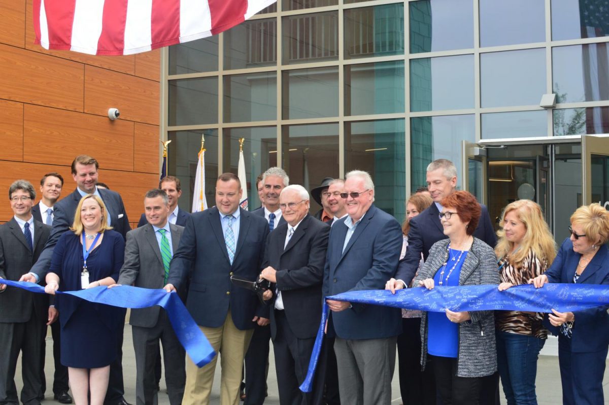 Members of the Permanent School Building Committee, School Committee, Board of Selectmen, and Massachusetts School Building Authority taking part in the ribbon cutting ceremony.