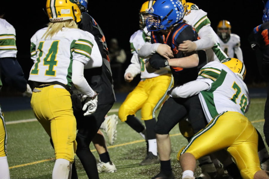 Brady Sheehan being tackled by Viking players 