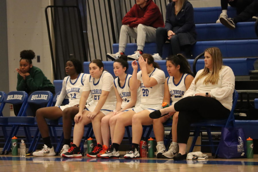 Varsity girls basketball team on the bench 