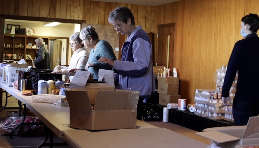 Volunteers helping package food for the pantry