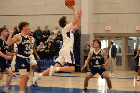 Owen Burke leaps in order to get the ball into the hoop