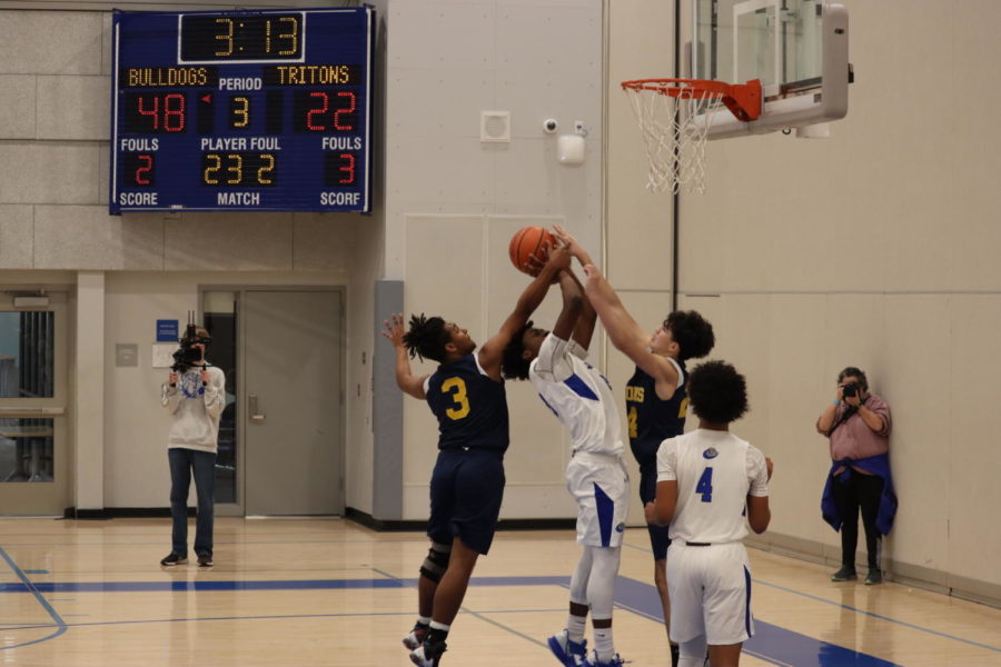 Armani Perkins getting blocked by opposing team as he makes a layup