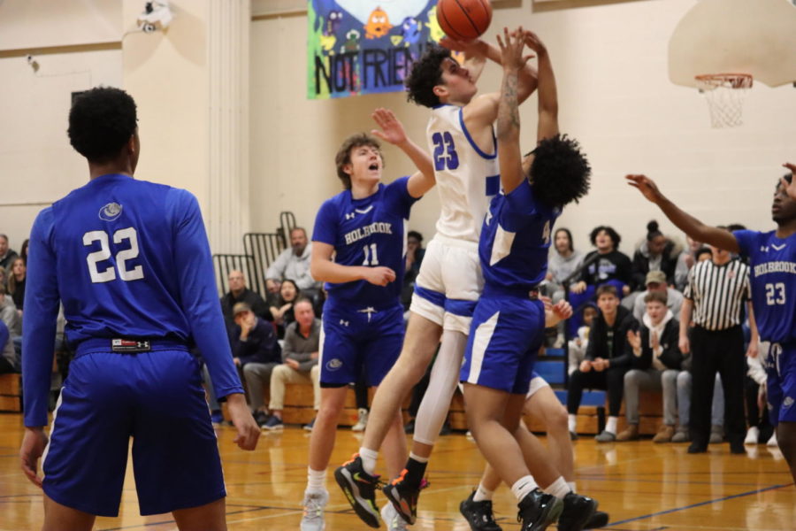 Marquis Dobay-Lindsay guards Hopedale player as they shoot the ball