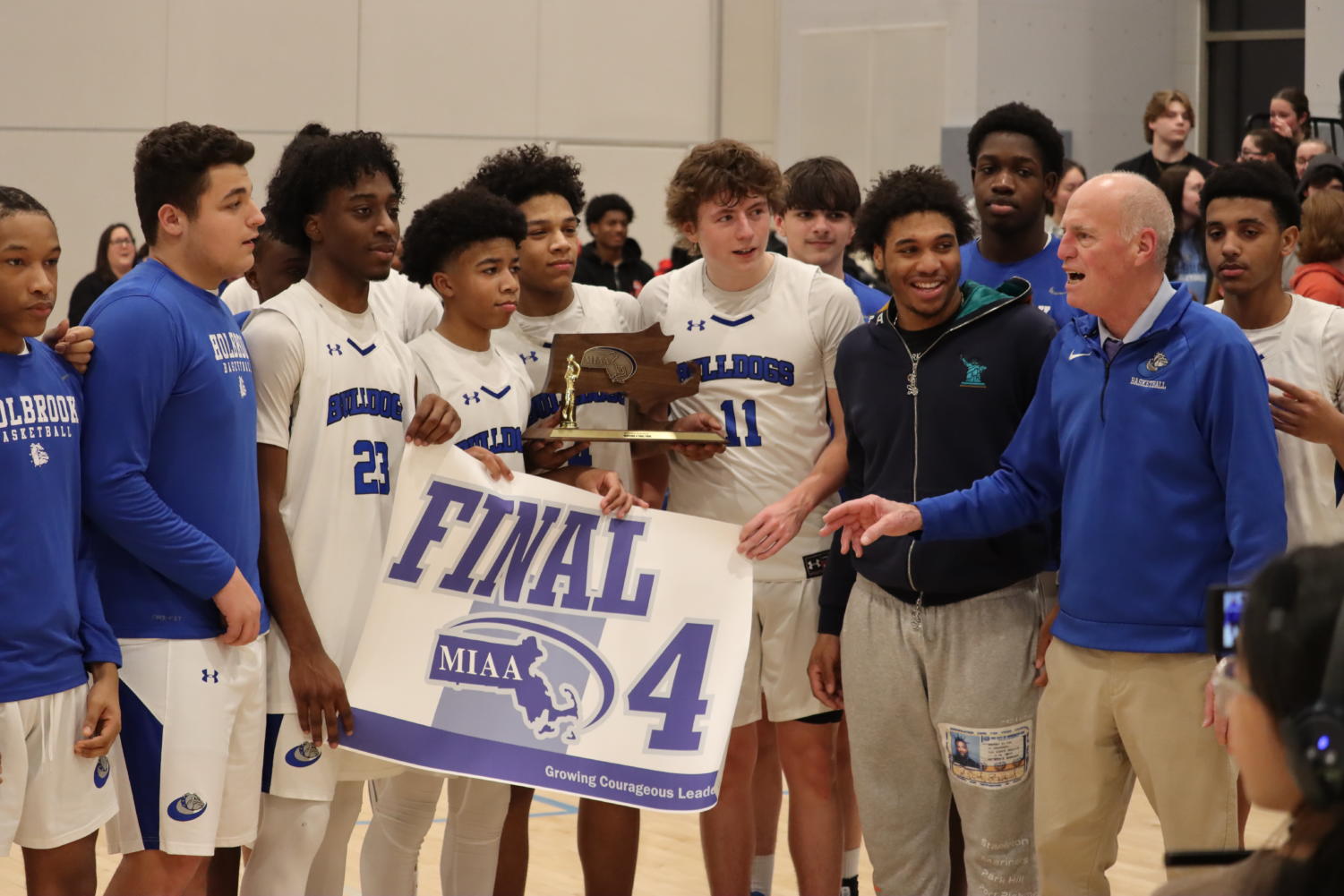 The team with their final 4 trophy and banner